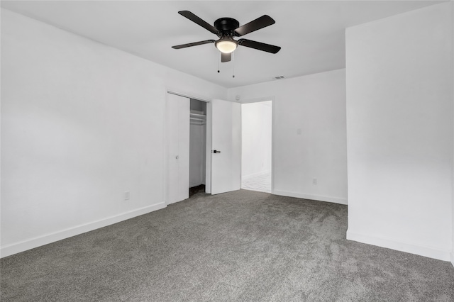 unfurnished bedroom featuring ceiling fan, a closet, and carpet