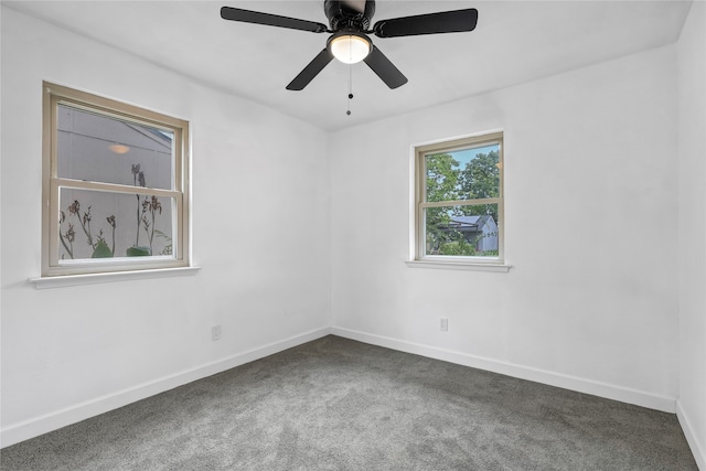 carpeted spare room featuring ceiling fan