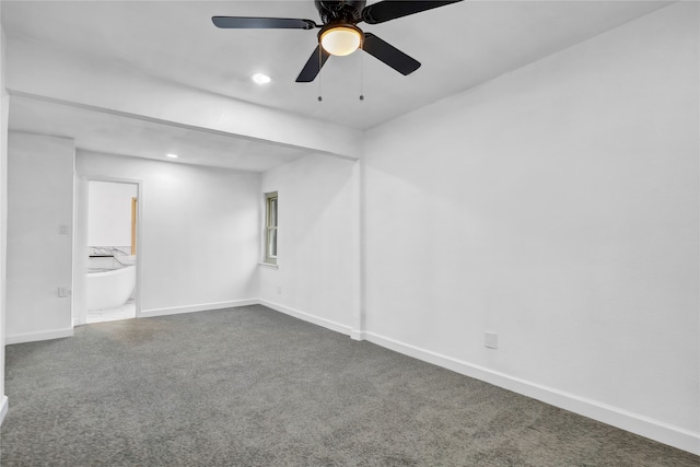 carpeted spare room featuring ceiling fan