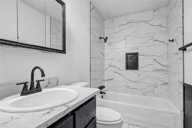 full bathroom featuring vanity, tiled shower / bath combo, and toilet