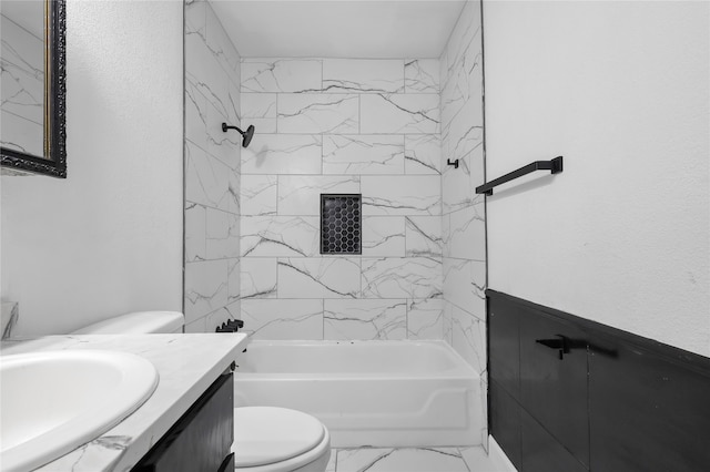 full bathroom featuring vanity, toilet, and tiled shower / bath