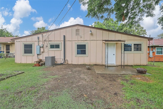 rear view of house with a yard, central AC, and a patio area