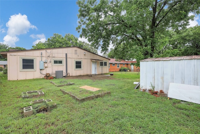 view of yard featuring central AC and a storage unit