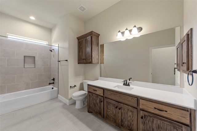 full bathroom featuring toilet, vanity, and tiled shower / bath