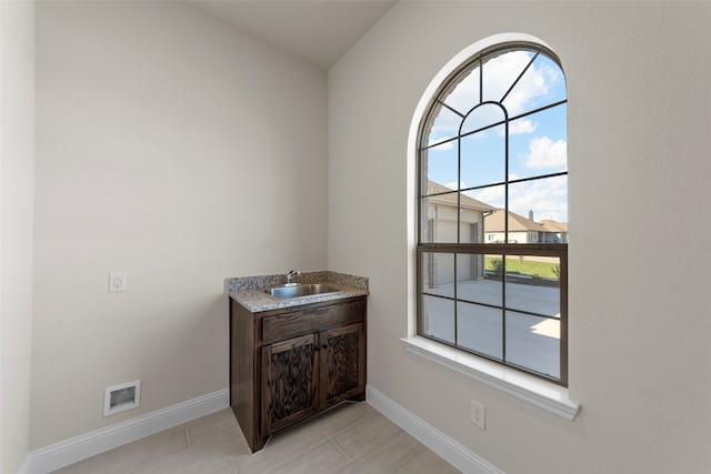 interior space with tile patterned floors, plenty of natural light, and sink