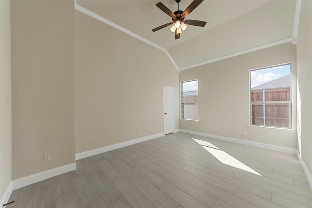 spare room with crown molding, vaulted ceiling, ceiling fan, and light wood-type flooring