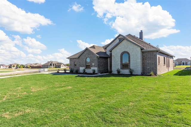 french country inspired facade featuring a front yard