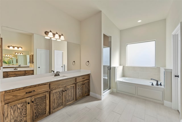 bathroom with vanity and separate shower and tub