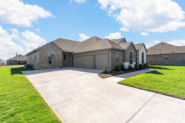 view of front of property with cooling unit, a garage, and a front lawn