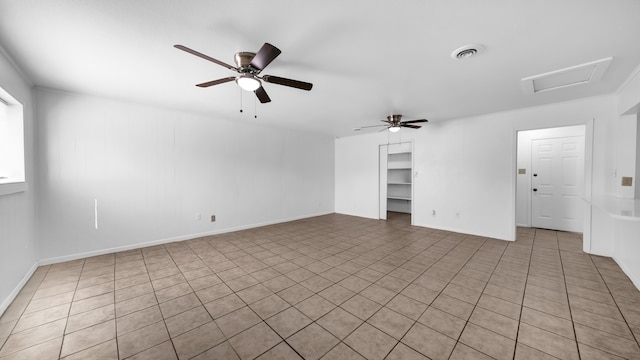 spare room with ceiling fan and light tile patterned floors