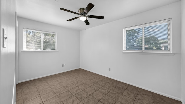 tiled spare room with ceiling fan and a healthy amount of sunlight