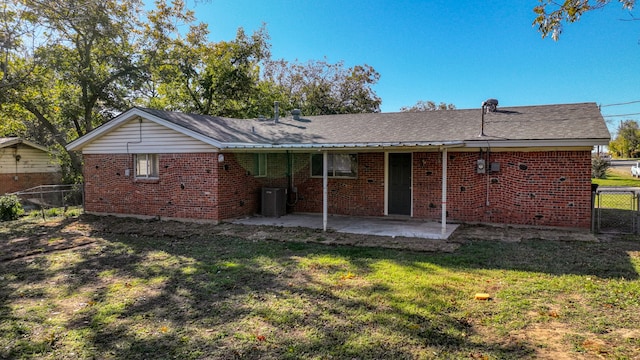 rear view of house with a yard, a patio, and cooling unit