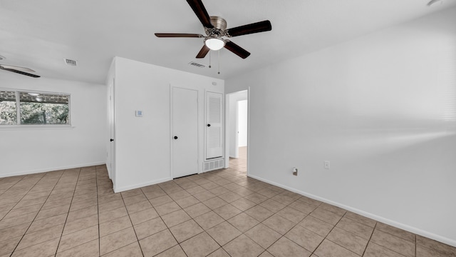 unfurnished room featuring light tile patterned flooring and ceiling fan