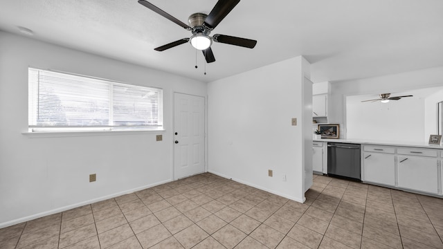 kitchen featuring ceiling fan, white cabinets, stainless steel dishwasher, and light tile patterned floors