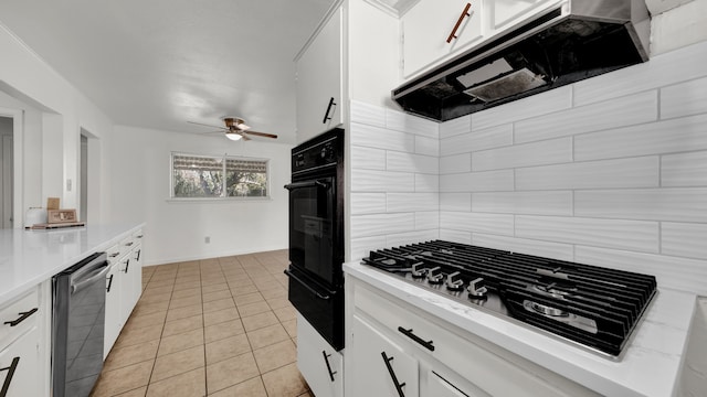 kitchen with white cabinetry, oven, and stainless steel dishwasher