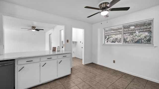 kitchen with white cabinets, light tile patterned floors, stainless steel dishwasher, and ceiling fan