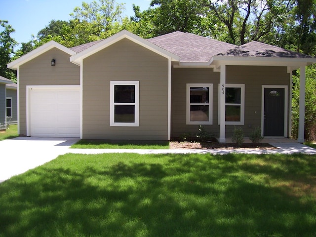 ranch-style house featuring a garage and a front yard