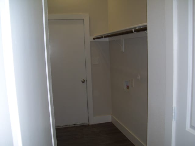 clothes washing area featuring dark wood-type flooring and washer hookup