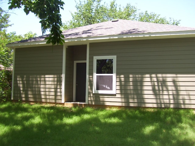 rear view of property with a lawn