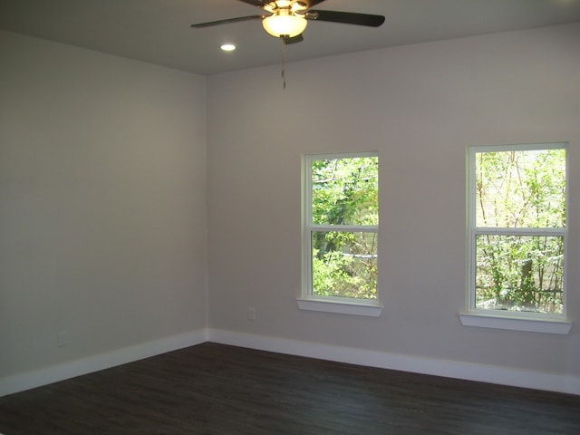 spare room featuring ceiling fan and dark hardwood / wood-style flooring