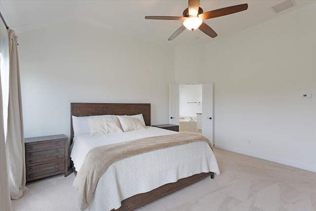 bedroom featuring light carpet, connected bathroom, ceiling fan, and ornamental molding