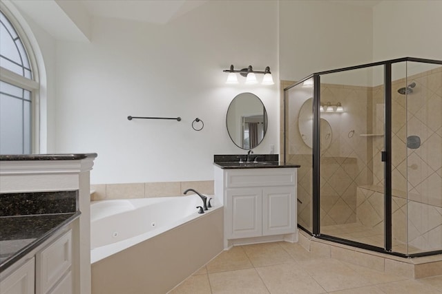 bathroom featuring tile patterned floors, vanity, and shower with separate bathtub