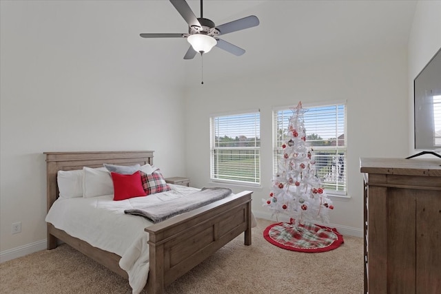 carpeted bedroom featuring a towering ceiling and ceiling fan