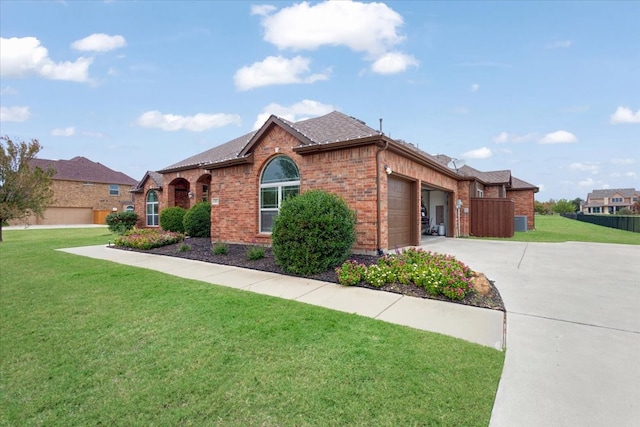 view of front of house featuring a garage and a front lawn