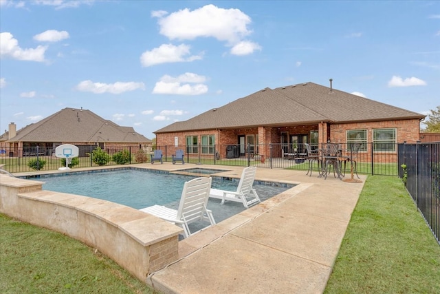 view of pool featuring a lawn and a patio area