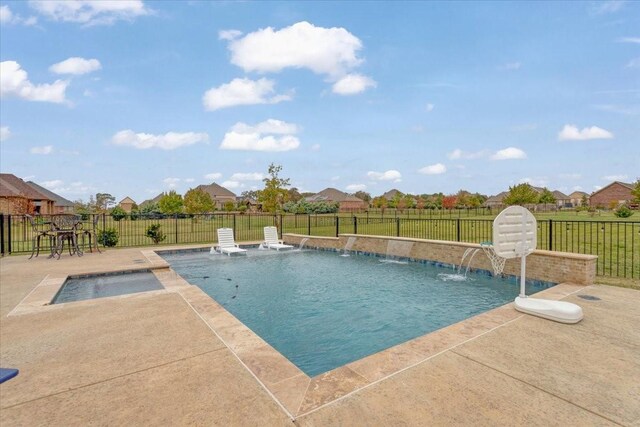 view of swimming pool featuring pool water feature, a patio area, and a lawn