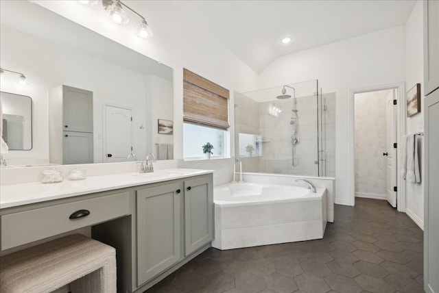 bathroom with tile patterned floors, vanity, lofted ceiling, and shower with separate bathtub