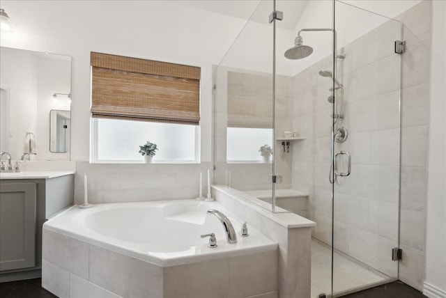 bathroom with vanity and separate shower and tub