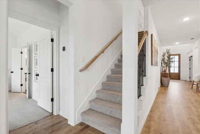 staircase featuring wood-type flooring