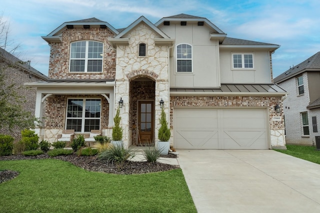 view of front of property with a garage and a front lawn