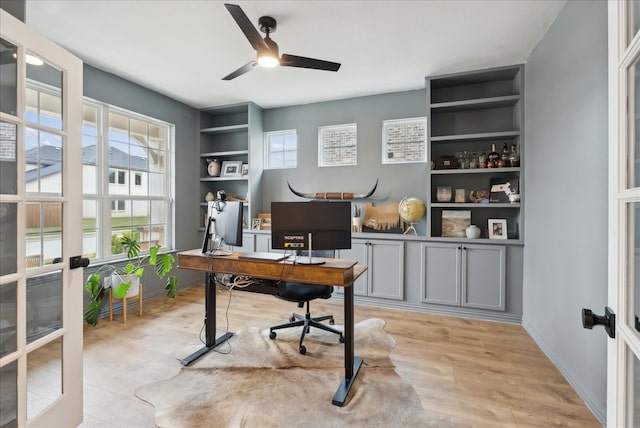 office area featuring french doors, light hardwood / wood-style flooring, and ceiling fan