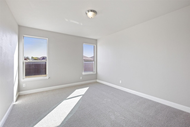 empty room with carpet flooring and plenty of natural light