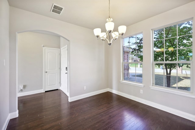 unfurnished room with dark wood-type flooring and a chandelier