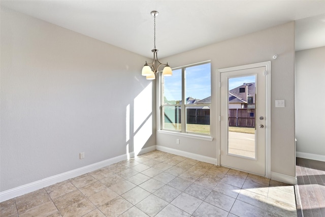 unfurnished dining area with a chandelier