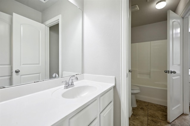 bathroom with tile patterned floors, vanity, and toilet