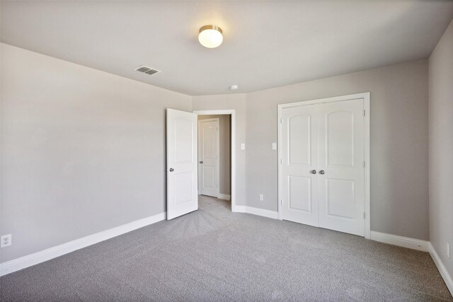 unfurnished bedroom with a closet and carpet