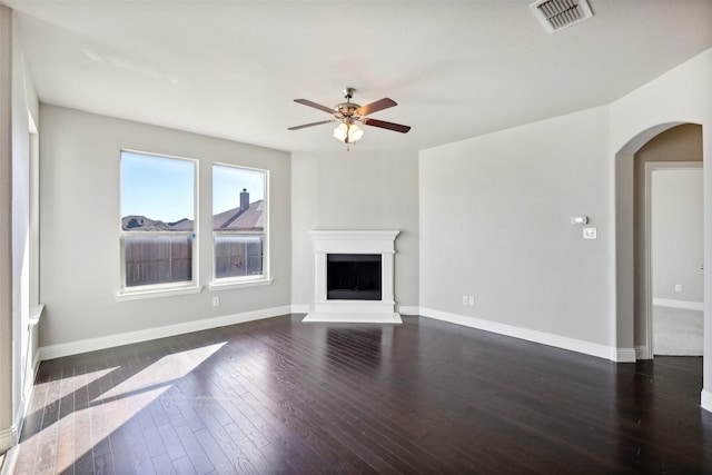 unfurnished living room featuring ceiling fan and dark hardwood / wood-style flooring