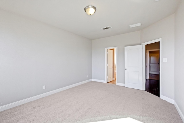 unfurnished bedroom featuring light carpet