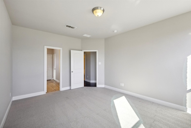 unfurnished bedroom featuring light carpet