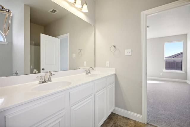 bathroom with tile patterned flooring and vanity