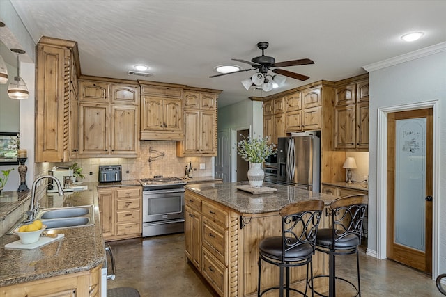 kitchen featuring appliances with stainless steel finishes, a center island, dark stone countertops, and sink