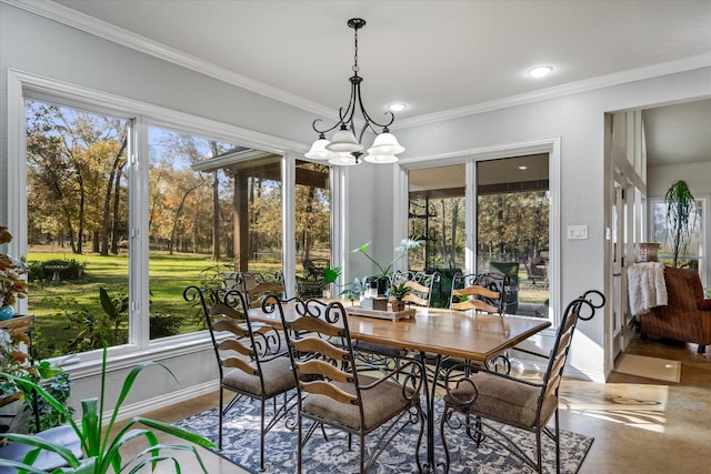 sunroom / solarium featuring a healthy amount of sunlight and a notable chandelier