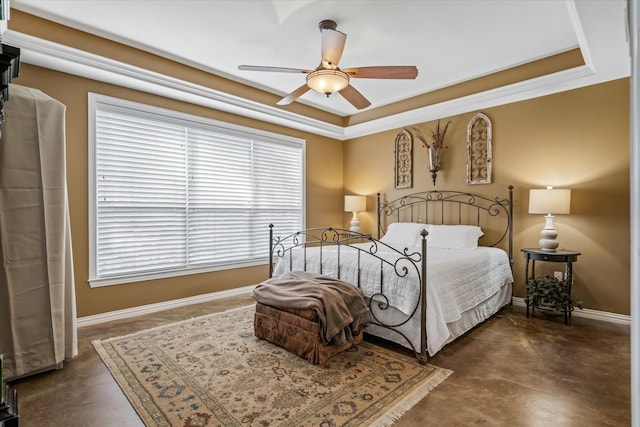 bedroom featuring a raised ceiling, ceiling fan, and ornamental molding