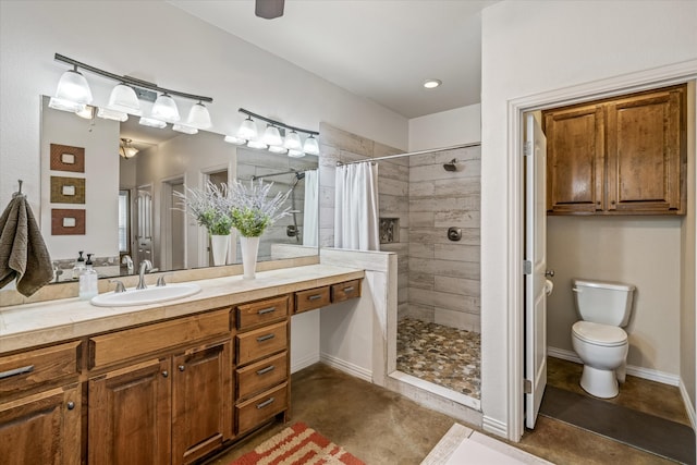 bathroom with curtained shower, vanity, concrete flooring, and toilet