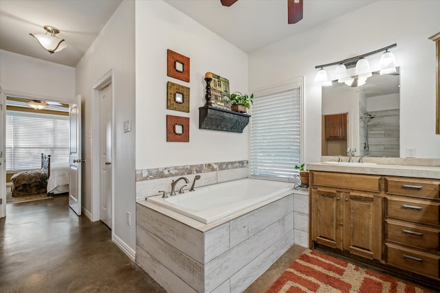 bathroom with a relaxing tiled tub, vanity, and concrete floors