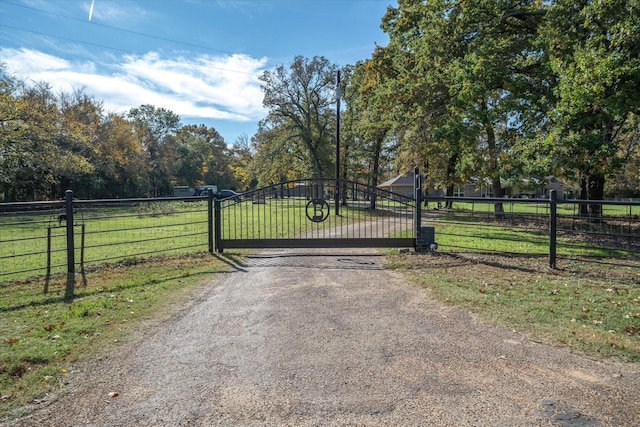 view of gate with a lawn